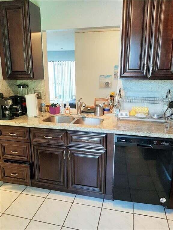 1679 Northwest 15th Vista Boca Raton, FL 33432 - Photo 7 of 15 a kitchen with a sink stove and cabinets