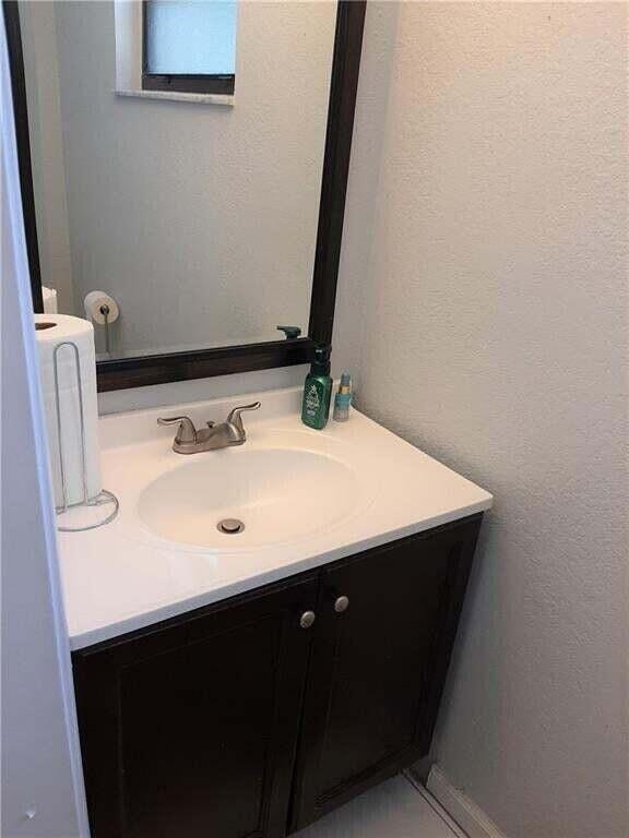 1679 Northwest 15th Vista Boca Raton, FL 33432 - Photo 8 of 15 a bathroom with a sink vanity and a mirror