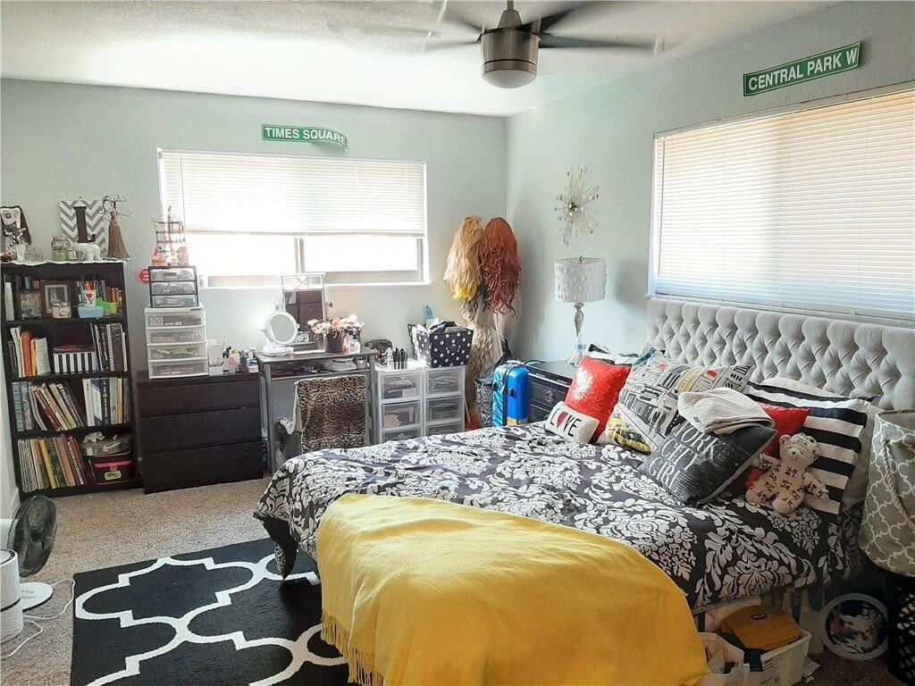 1679 Northwest 15th Vista Boca Raton, FL 33432 - Photo 9 of 15 a bedroom with a bed and wooden floor