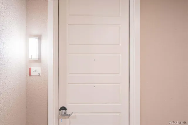 a kitchen with a refrigerator and a stove top oven