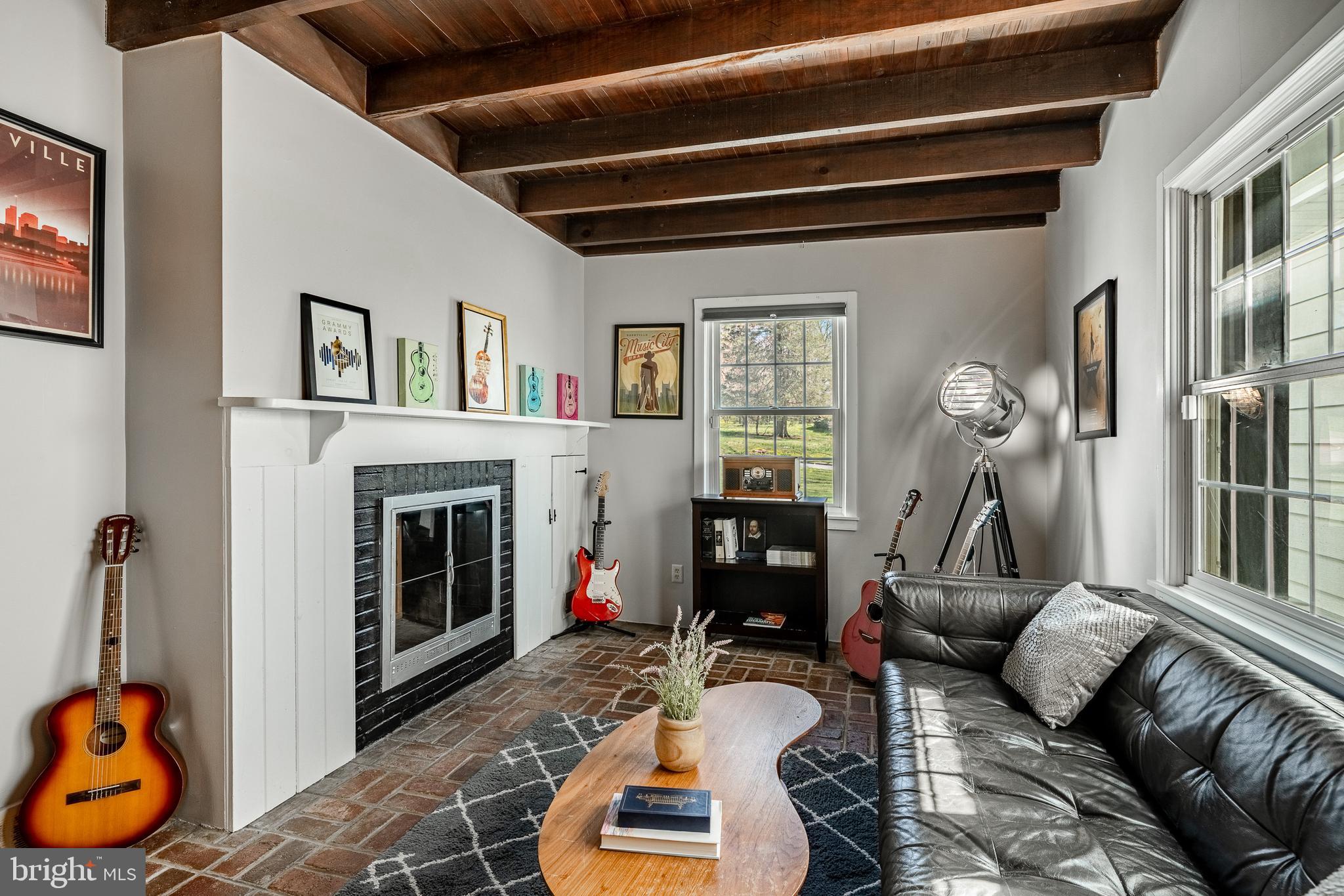 466 Barclay Road Bryn Mawr, PA 19010 - Photo 25 of 62 a living room with furniture a fireplace and gym equipment