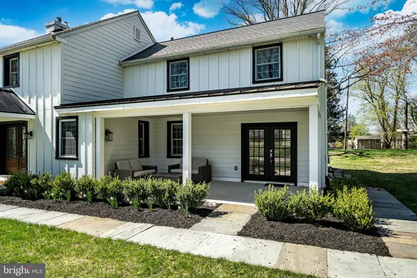 a living room with furniture a fireplace and gym equipment
