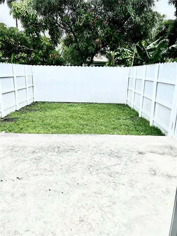 a view of yard with large trees