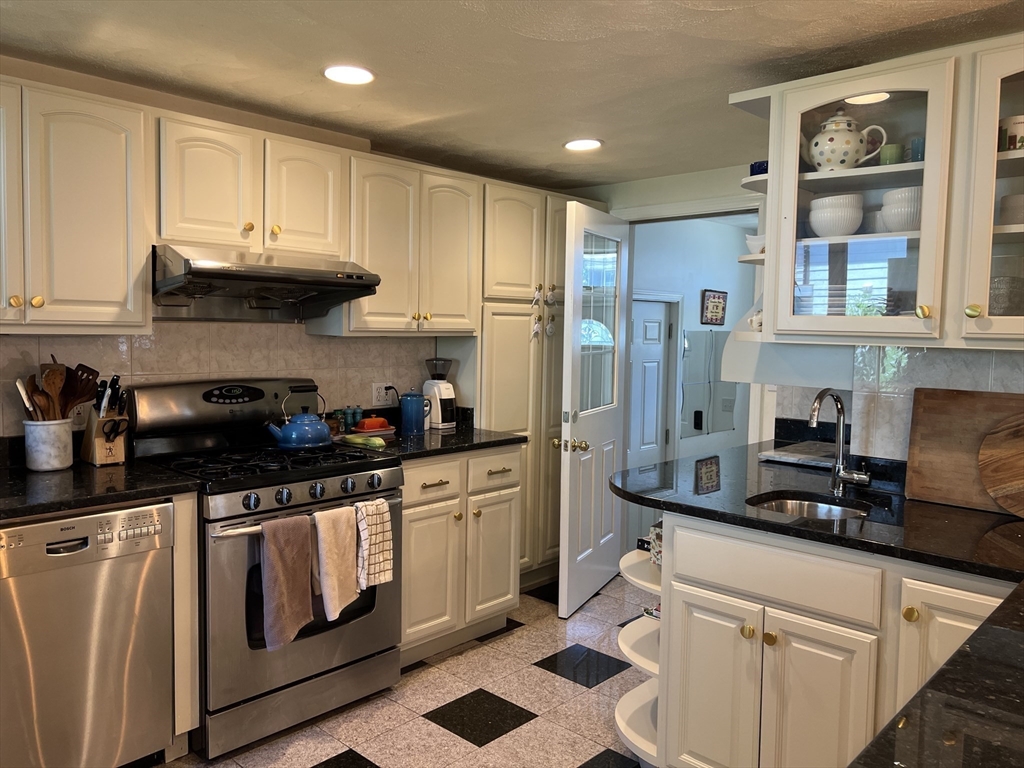 11 Garrison Road, Unit 1 Arlington, MA 02474 - Photo 3 of 42 a kitchen with stainless steel appliances a stove a sink and cabinets