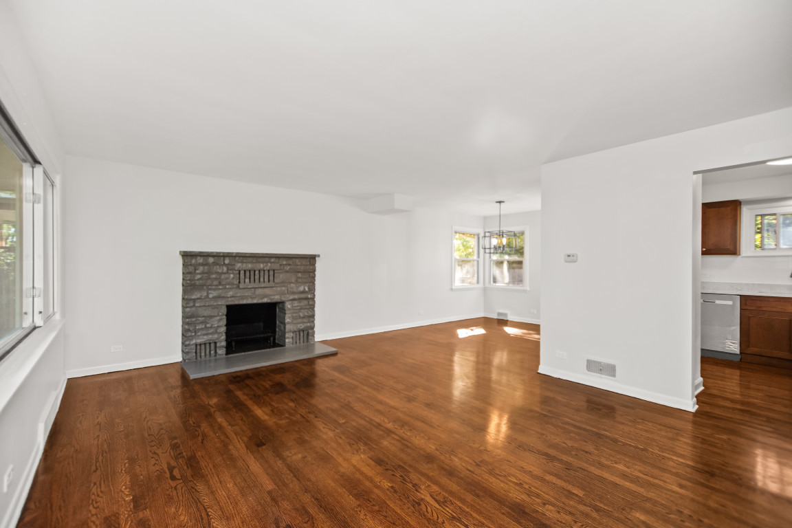 1808 Laurel Avenue Evanston, IL 60201 - Photo 2 of 15 an empty room with wooden floor fireplace and windows