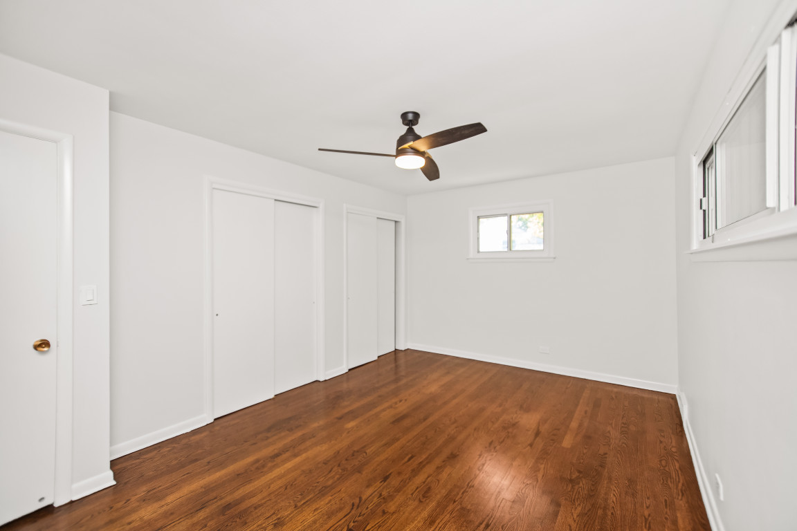 1808 Laurel Avenue Evanston, IL 60201 - Photo 6 of 15 an empty room with wooden floor and windows