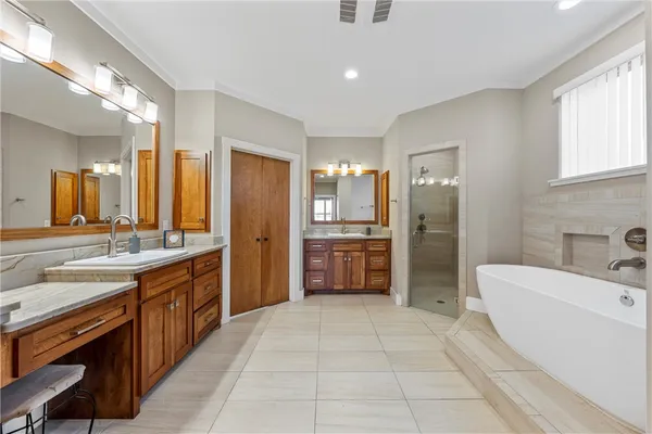 a large bathroom with a large mirror sink and stainless steel appliances