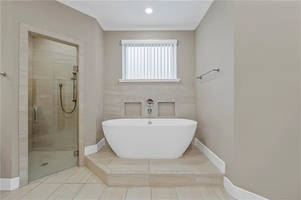 a bathroom with a bathtub and shower