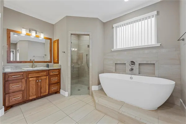 a spacious bathroom with a double vanity sink mirror and bathtub