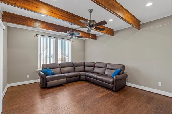 a living room with furniture and a ceiling fan