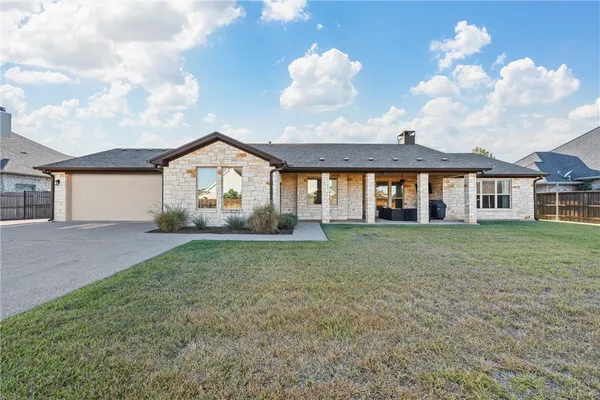 a view of house with yard and entertaining space