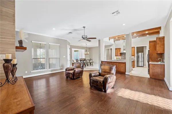 a living room with furniture window and wooden floor