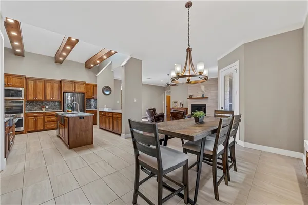 a view of a dining room with furniture and chandelier