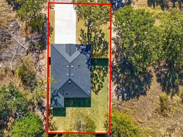 an aerial view of houses with a yard