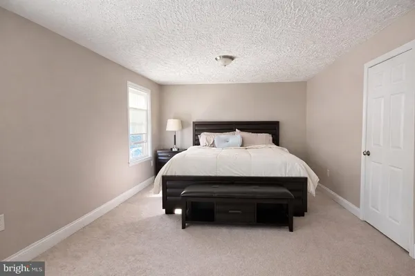 a bed sitting in a room next to a window