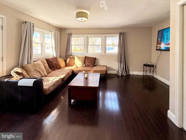 a living room with furniture window and wooden floor