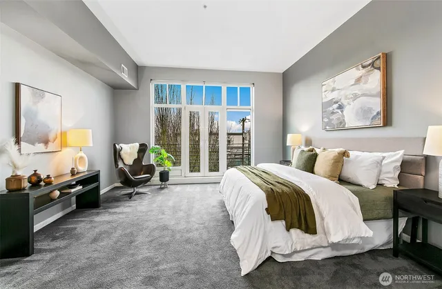 a spacious bedroom with a bed a couch and a window