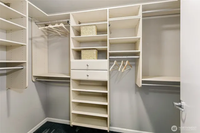 a view of walk in closet with empty racks