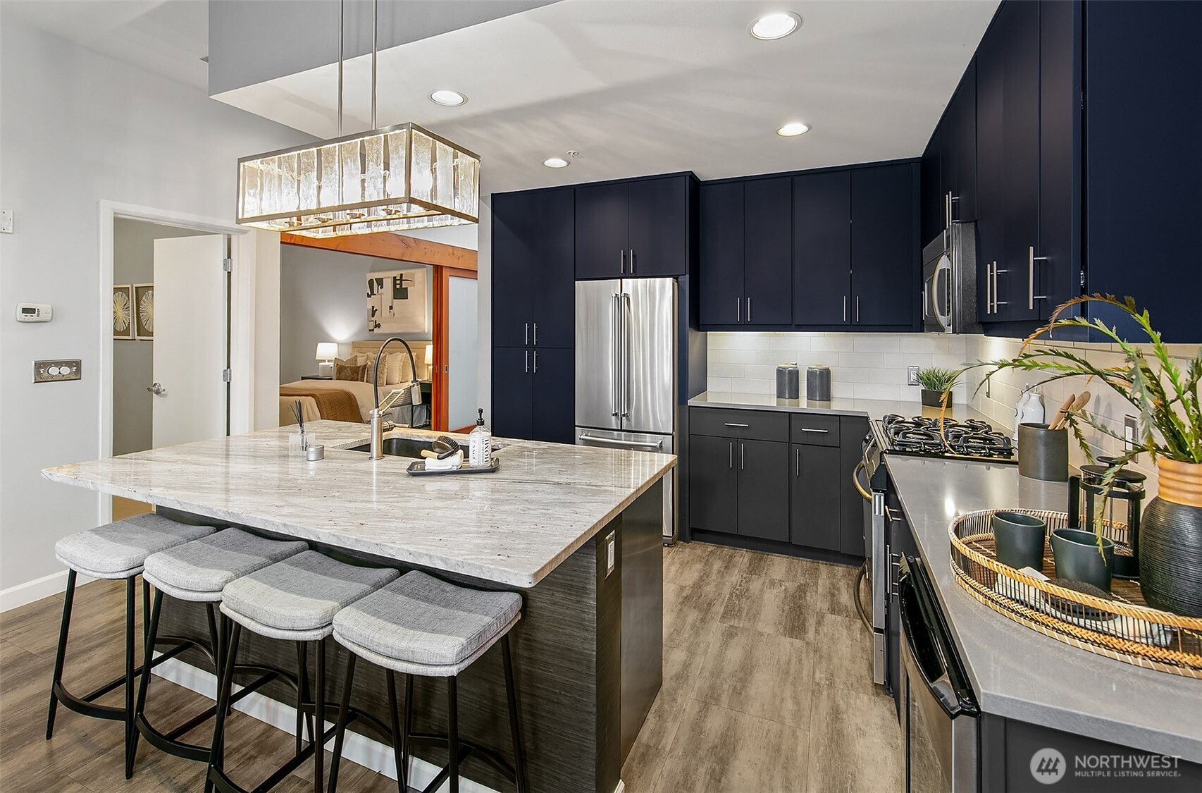 17 West Mercer Street, Unit 302 Seattle, WA 98119 - Photo 17 of 28 a kitchen with granite countertop a table chairs stove and refrigerator