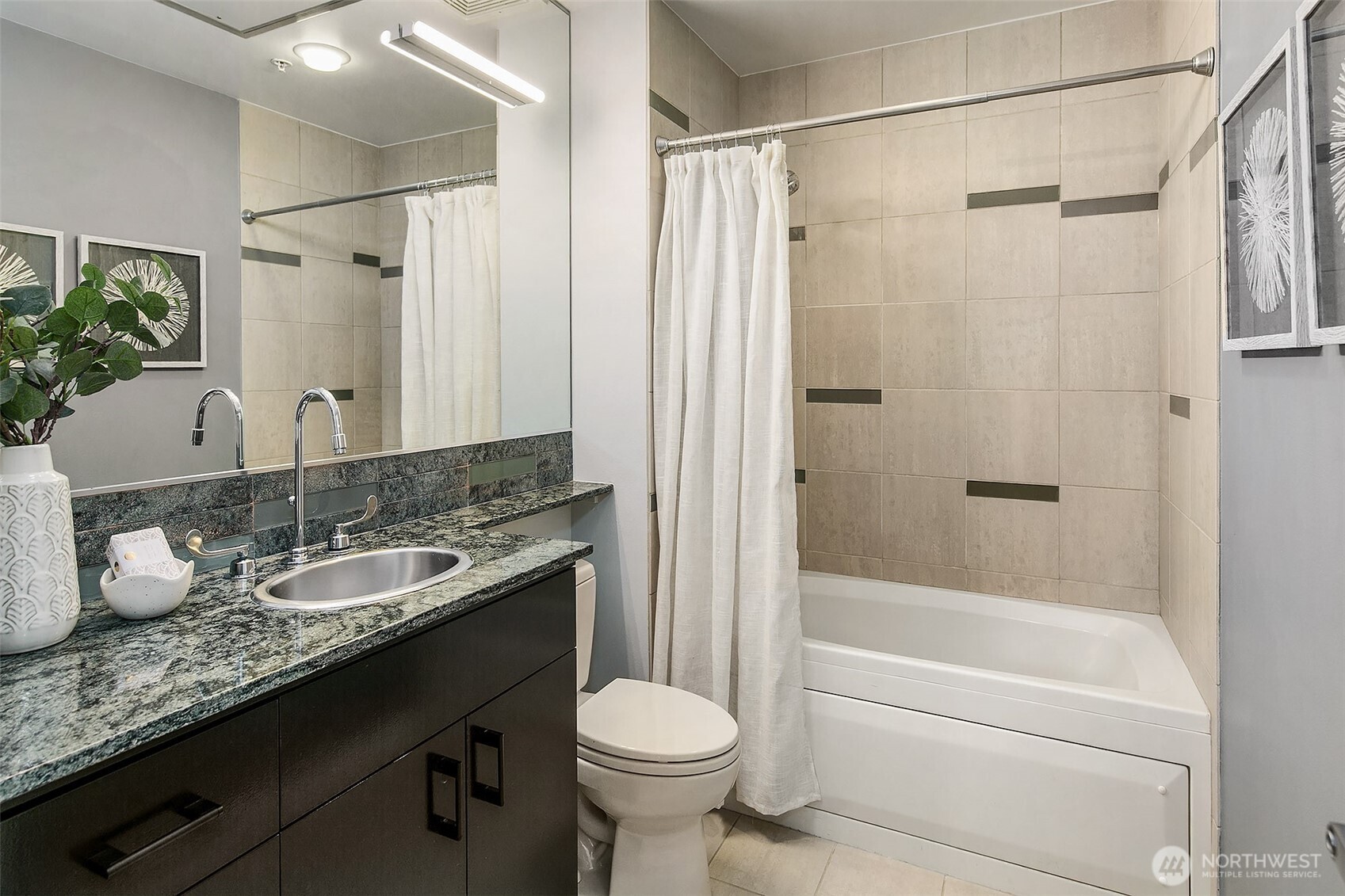 17 West Mercer Street, Unit 302 Seattle, WA 98119 - Photo 18 of 28 a bathroom with a granite countertop sink toilet and shower
