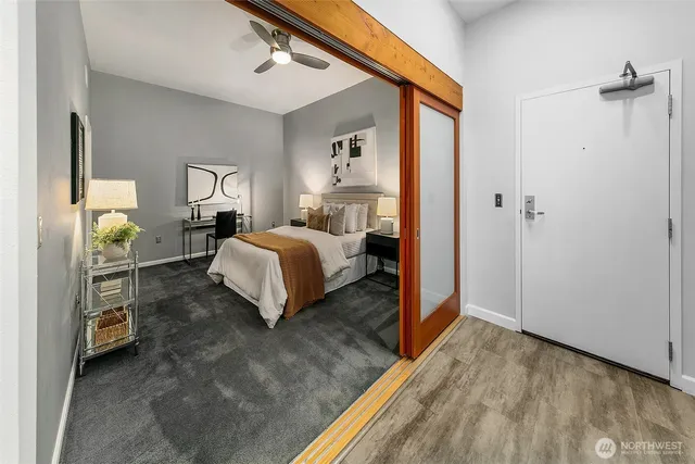 a bedroom with a bed and a dresser with mirror