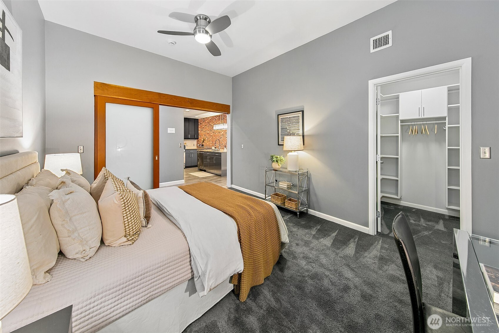 17 West Mercer Street, Unit 302 Seattle, WA 98119 - Photo 21 of 28 a bedroom with a bed and a chandelier