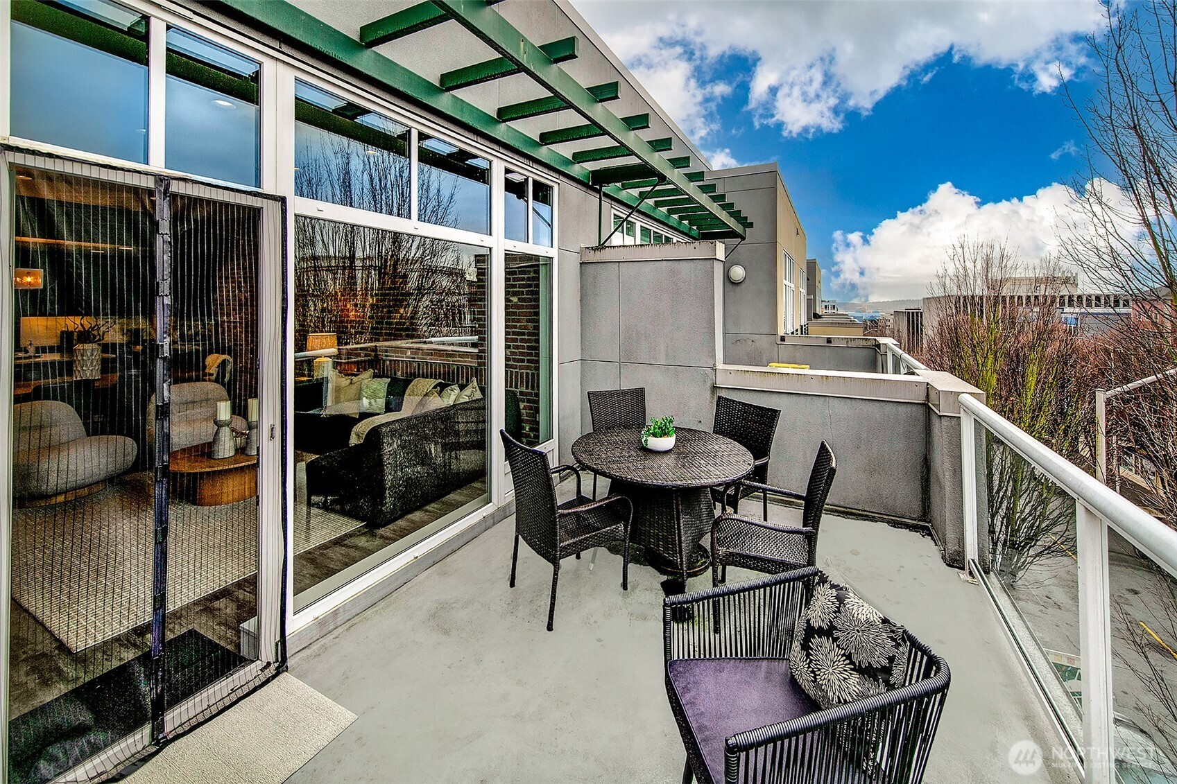 17 West Mercer Street, Unit 302 Seattle, WA 98119 - Photo 6 of 28 a balcony with table and chairs