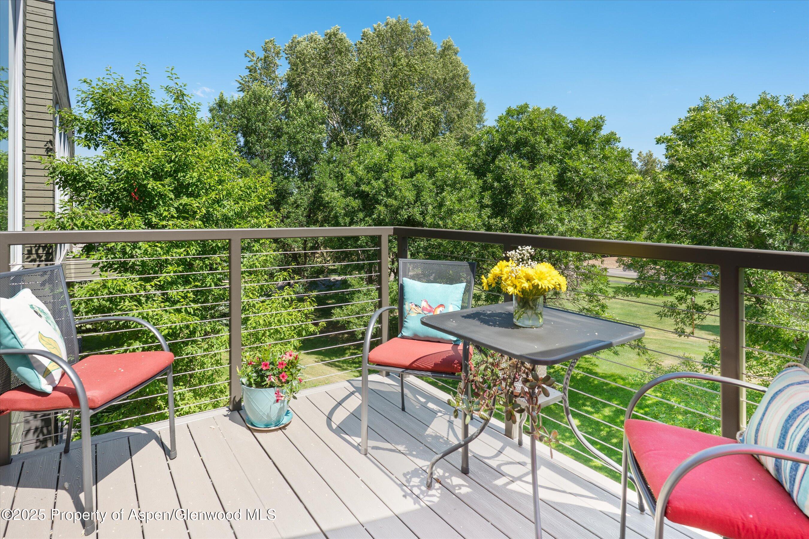 202 Evans Road, Unit 202 Basalt, CO 81621 - Photo 16 of 29 a balcony with wooden floor table and chairs
