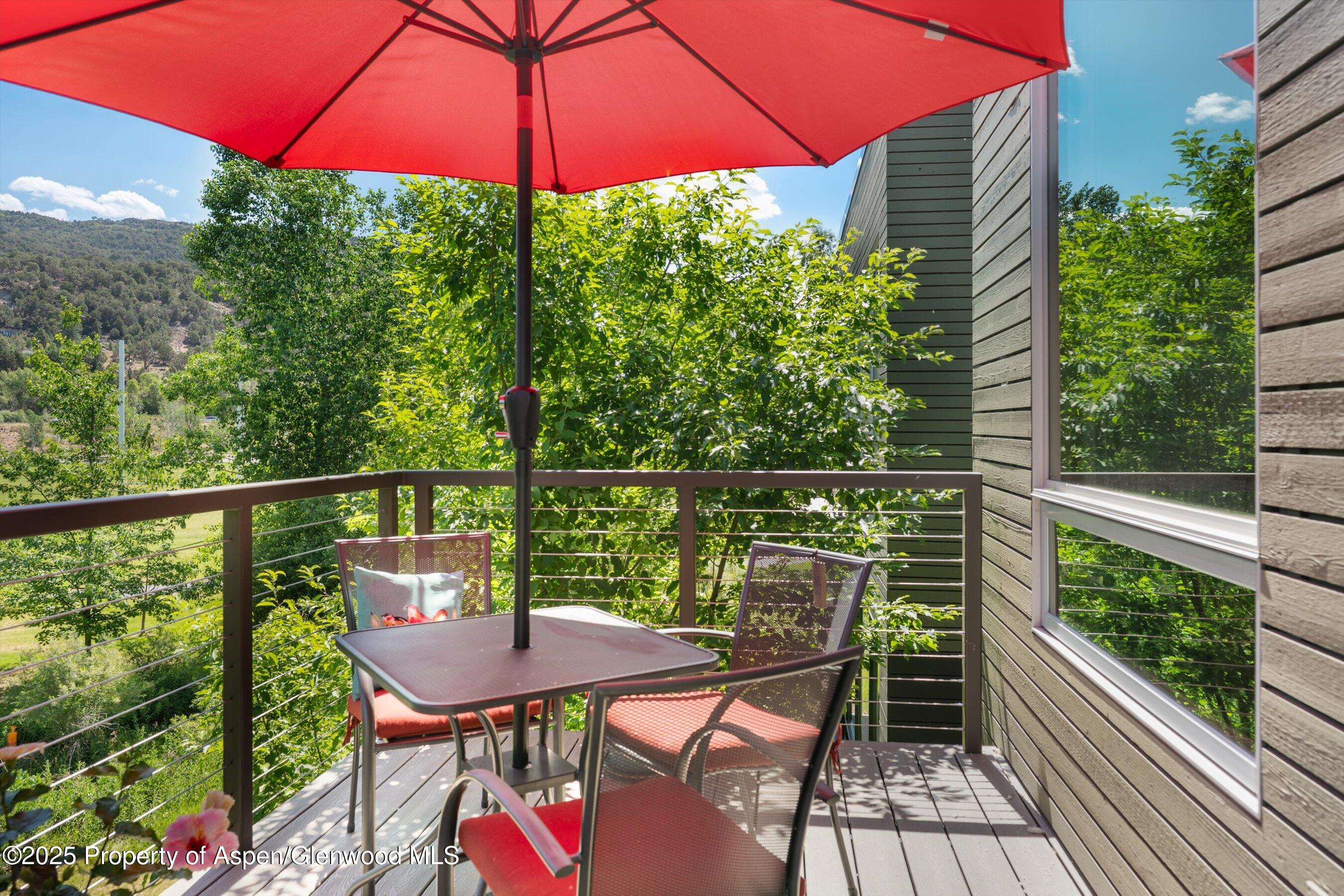 202 Evans Road, Unit 202 Basalt, CO 81621 - Photo 18 of 29 a view of a balcony with chairs and wooden floor