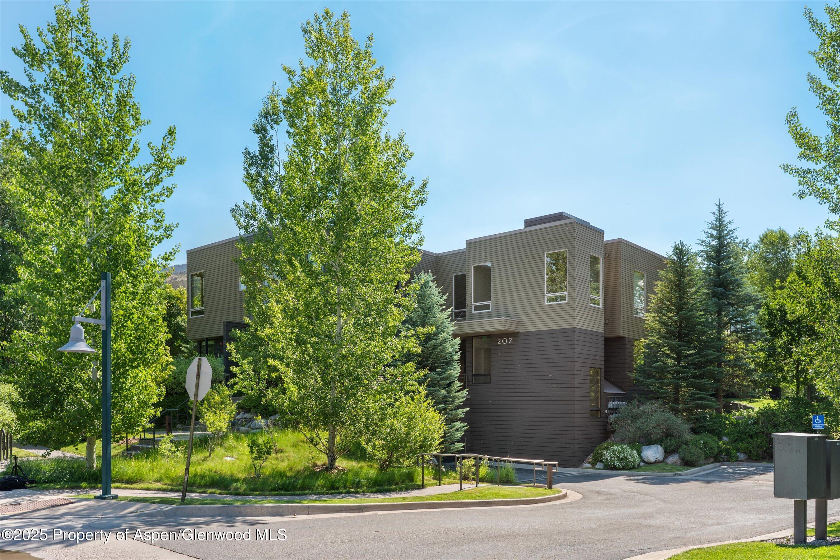 202 Evans Road, Unit 202 Basalt, CO 81621 - Photo 21 of 29 a front view of a house with a yard and garage
