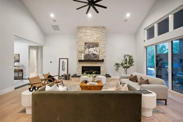 a kitchen with stainless steel appliances kitchen island granite countertop a refrigerator a stove a sink a dining table and chairs