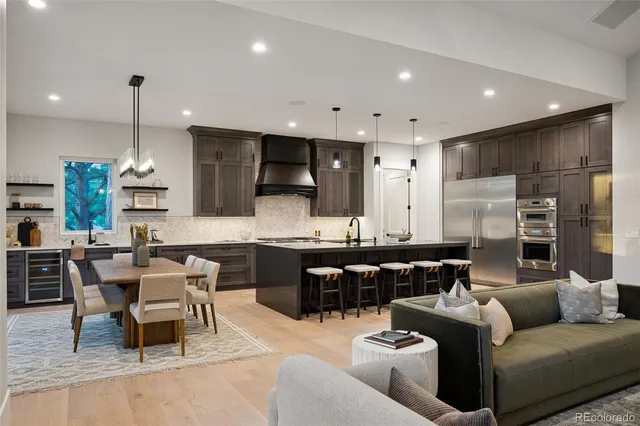 a kitchen with stainless steel appliances a sink a stove and a refrigerator