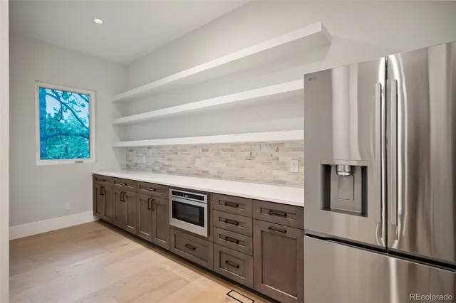 a spacious bathroom with a double vanity sink large mirror and a bathtub