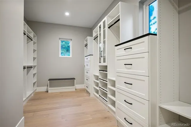 an empty room with a ceiling fan and windows
