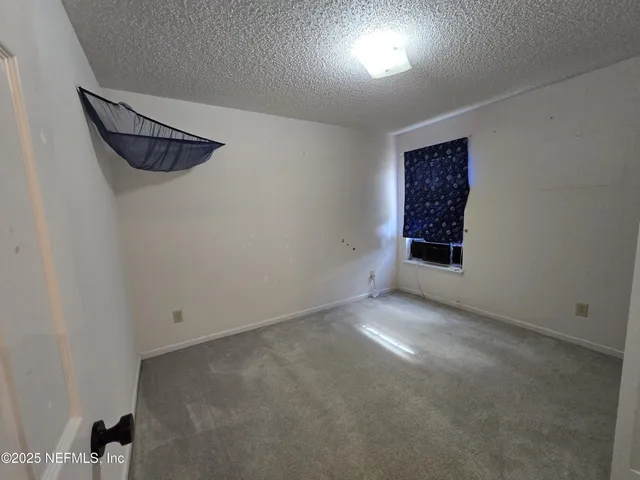 an empty room with windows and closet