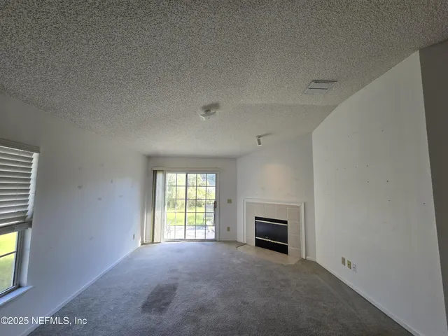 a view of empty room with a fireplace
