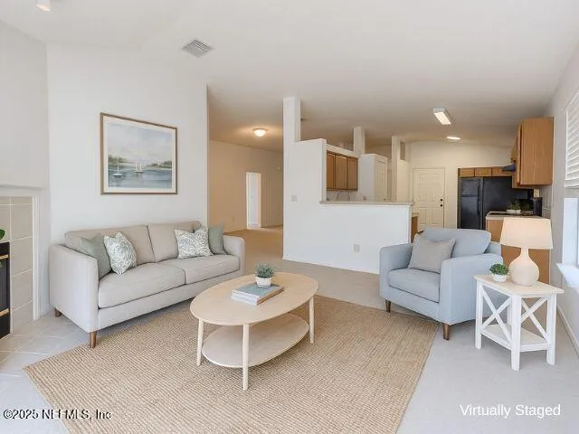 a living room with furniture and a painting