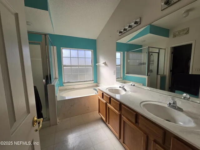 a bathroom with a granite countertop sink and a large mirror