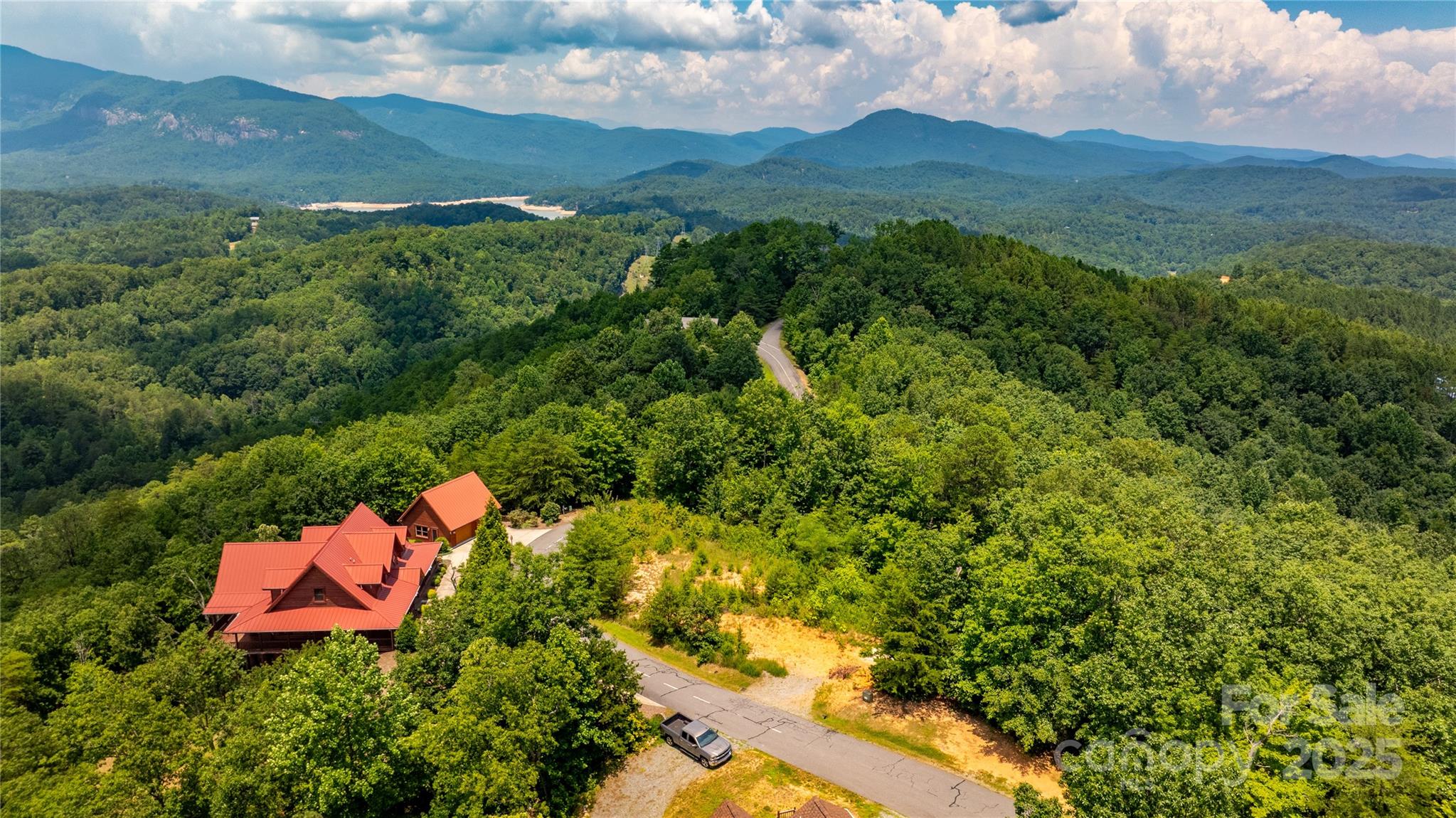 240 Boulder Ridge Lake Lure, NC 28746 - Photo 13 of 28 a view of a lush green hillside and a houses
