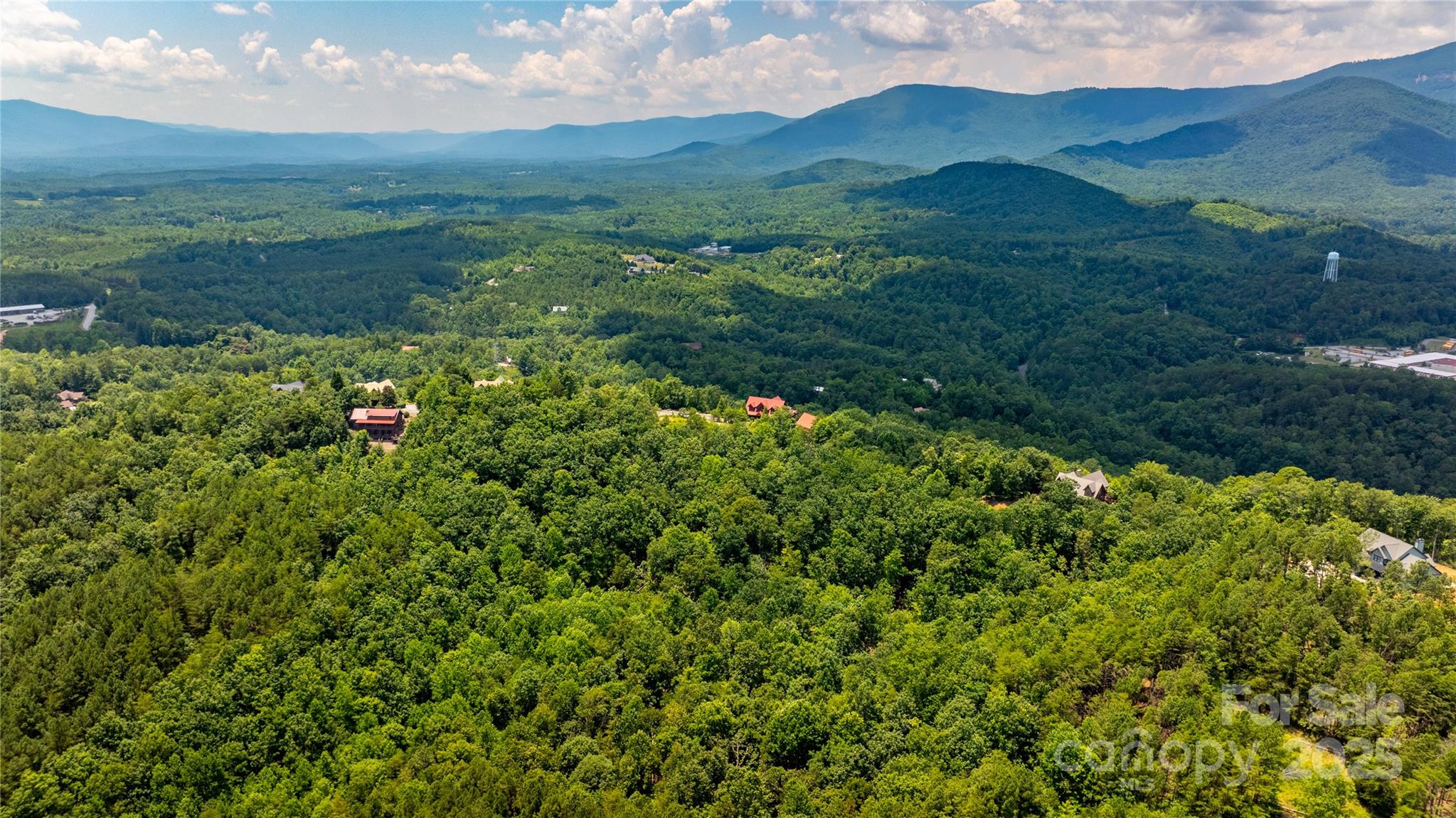 240 Boulder Ridge Lake Lure, NC 28746 - Photo 5 of 28 a view of a lush green hillside and a houses