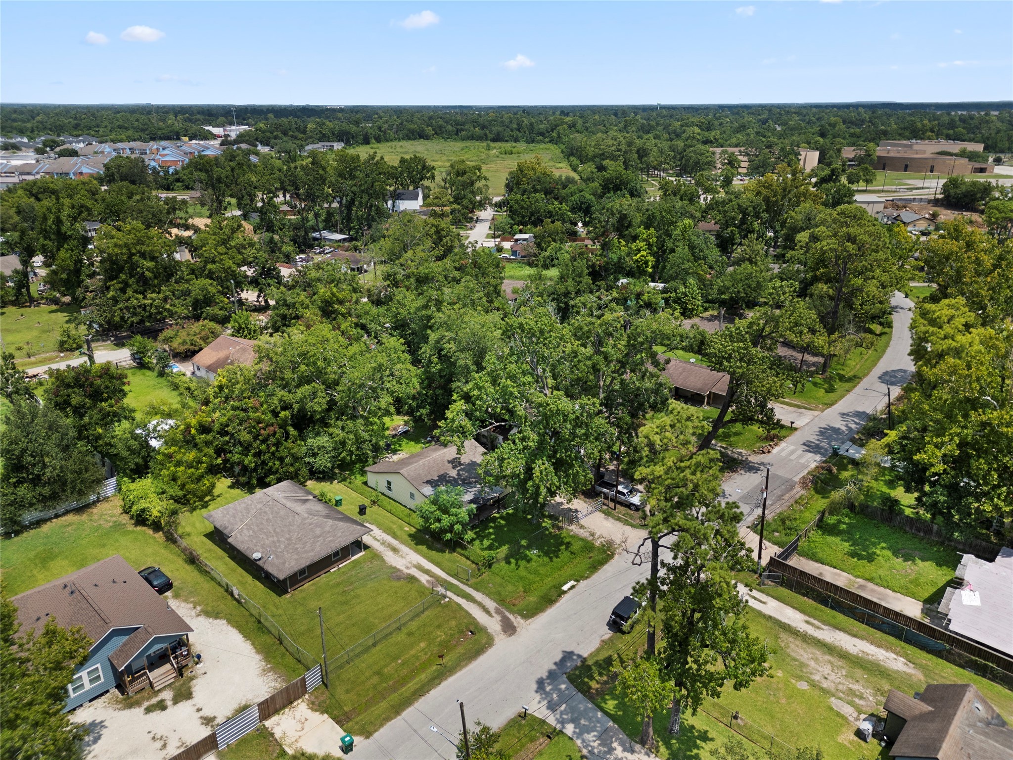 9313 Sherbourne Street Houston, TX 77016 - Photo 4 of 6 an aerial view of residential houses with outdoor space and trees