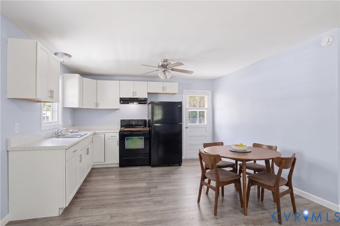 15503 Eppes Road Dewitt, VA 23840 - Photo 11 of 22 a kitchen with a table chairs refrigerator and cabinets