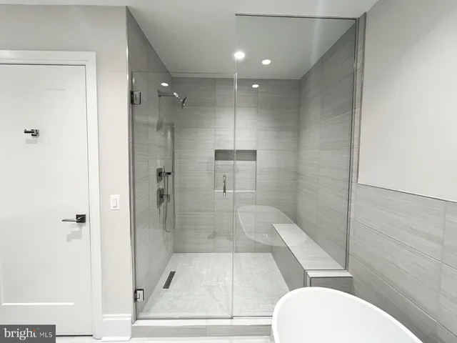 a bathroom with a glass shower door