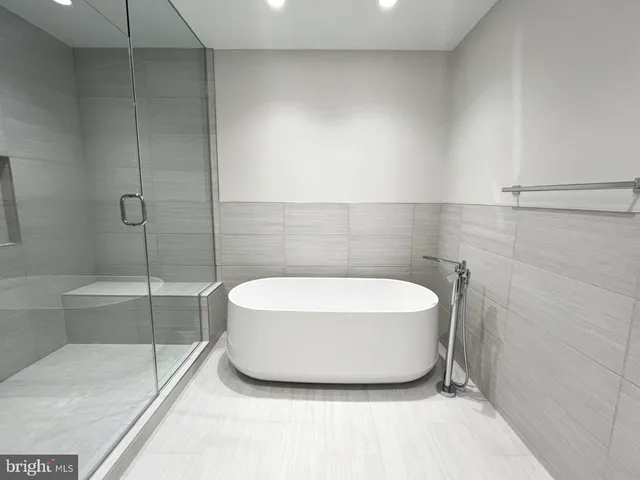a bathroom with a bathtub and shower