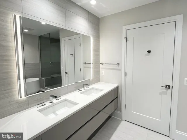 a bathroom with a double vanity sink and a mirror