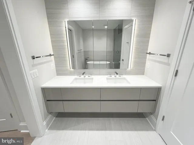 a bathroom with a sink vanity and a mirror