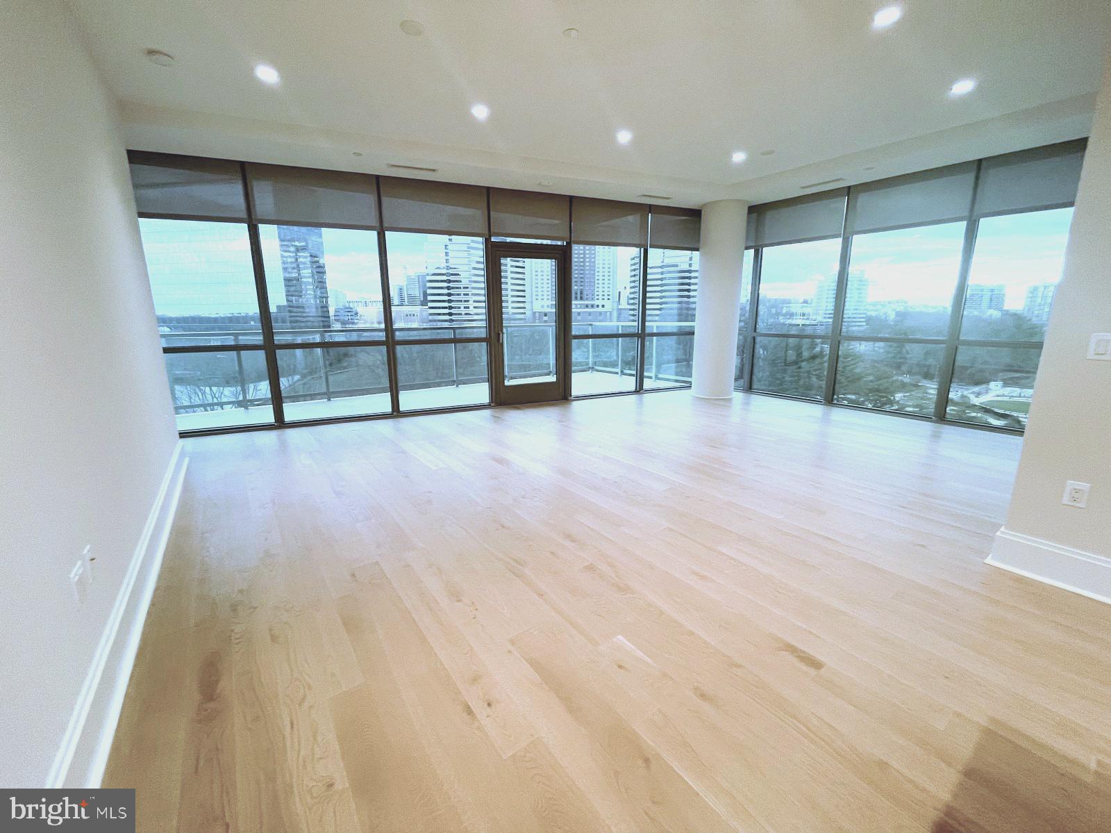 7887 Jones Branch Drive, Unit 1104 McLean, VA 22102 - Photo 2 of 42 an empty room with wooden floor and windows