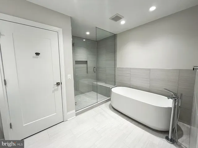 a bathroom with a bathtub and a shower