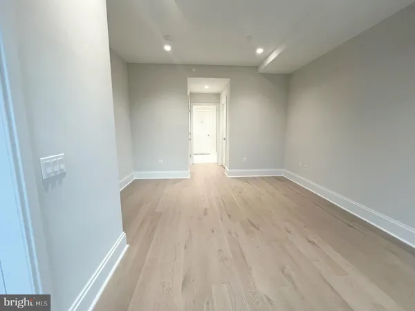 a view of wooden floor and windows in a room