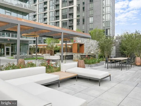 a view of a patio with couches and a table and chairs
